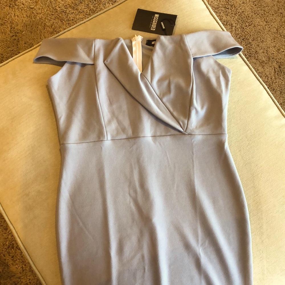 Elegant off the shoulder dress with cap sleeves.Knee length with a zippered back